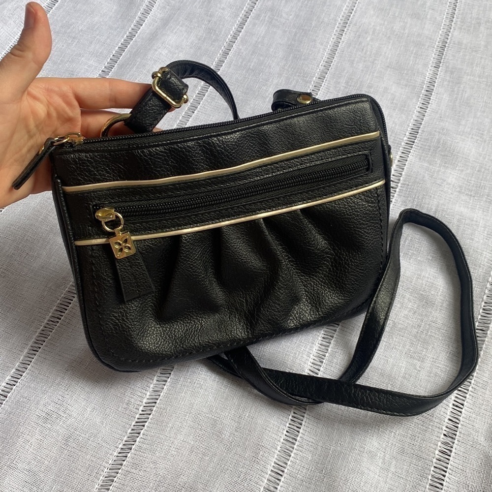 Relic small black crossbody bag with multiple pockets.